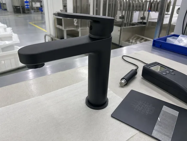 Matte black PVD finish bathroom faucet showing 0.3 to 0.5 micron coating thickness and cross-cut adhesion test result
