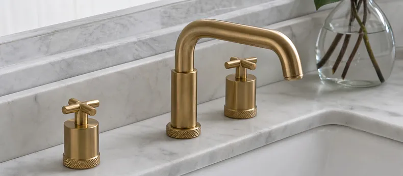 Brass bathroom faucet with unlacquered warm metal finish