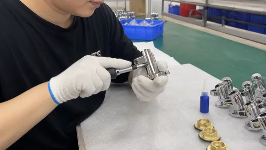 Handle set screw torque inspection at final assembly showing thread engagement and thread-lock application