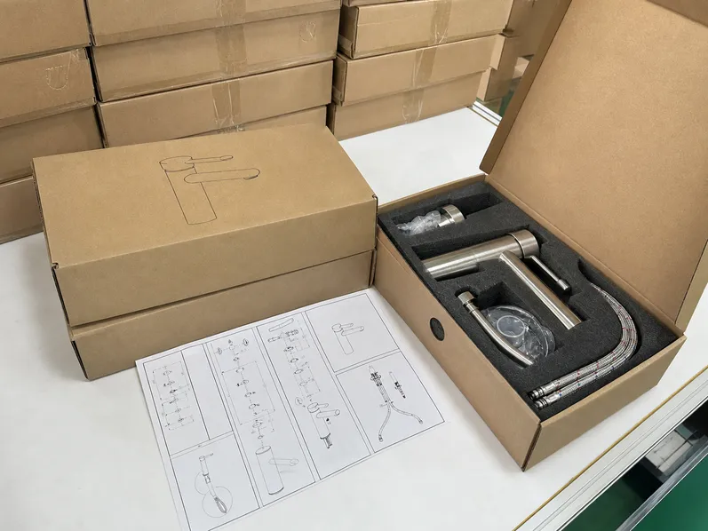 Custom OEM packaging line showing branded cartons, installation instructions, and retail-ready faucet packaging