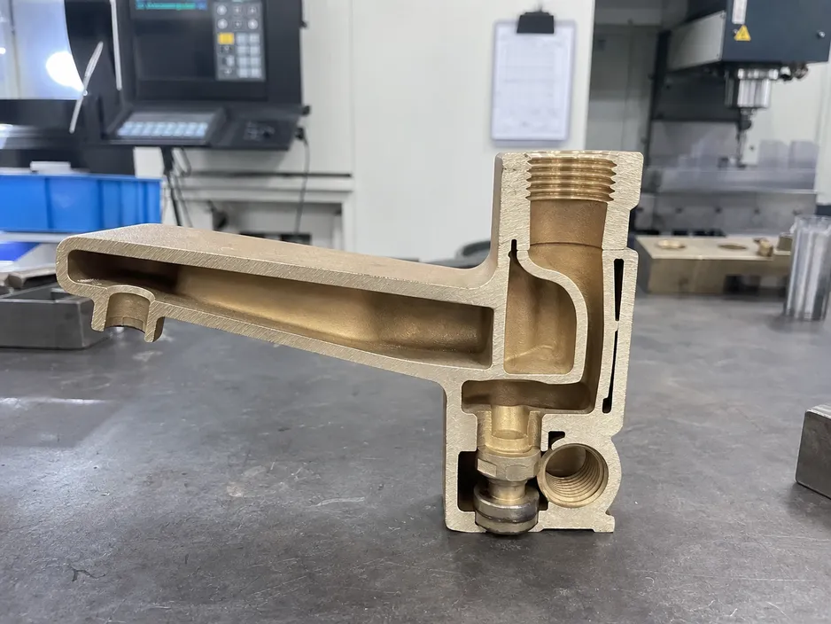 Single-piece brass gravity cast low profile faucet body showing internal waterway formation