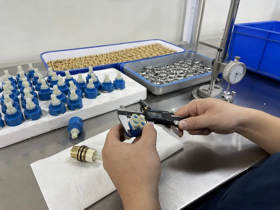 35mm ceramic disc cartridge used in low profile bathroom faucets, shown during quality inspection