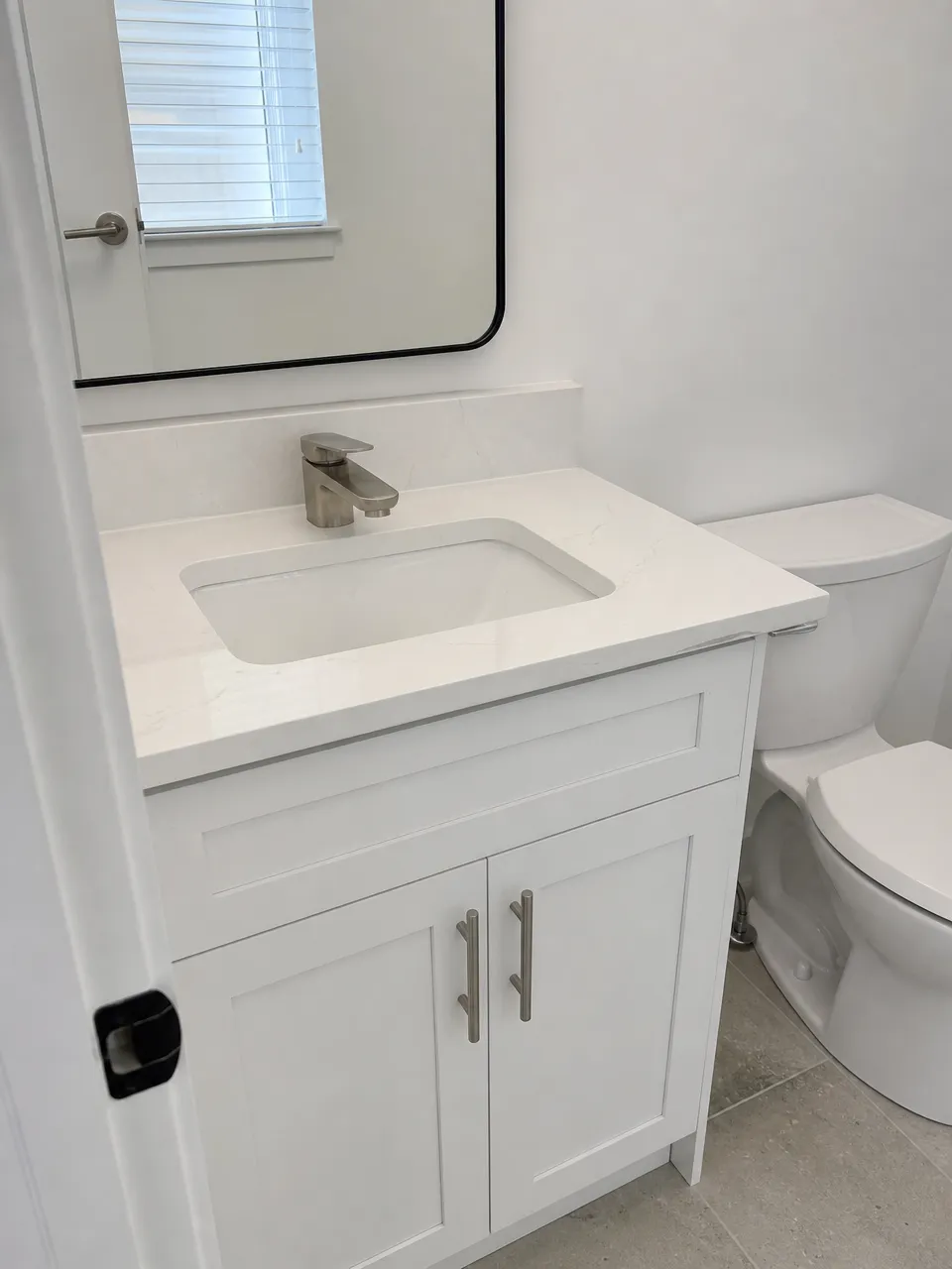 Low profile faucet on compact powder room vanity with shallow counter depth
