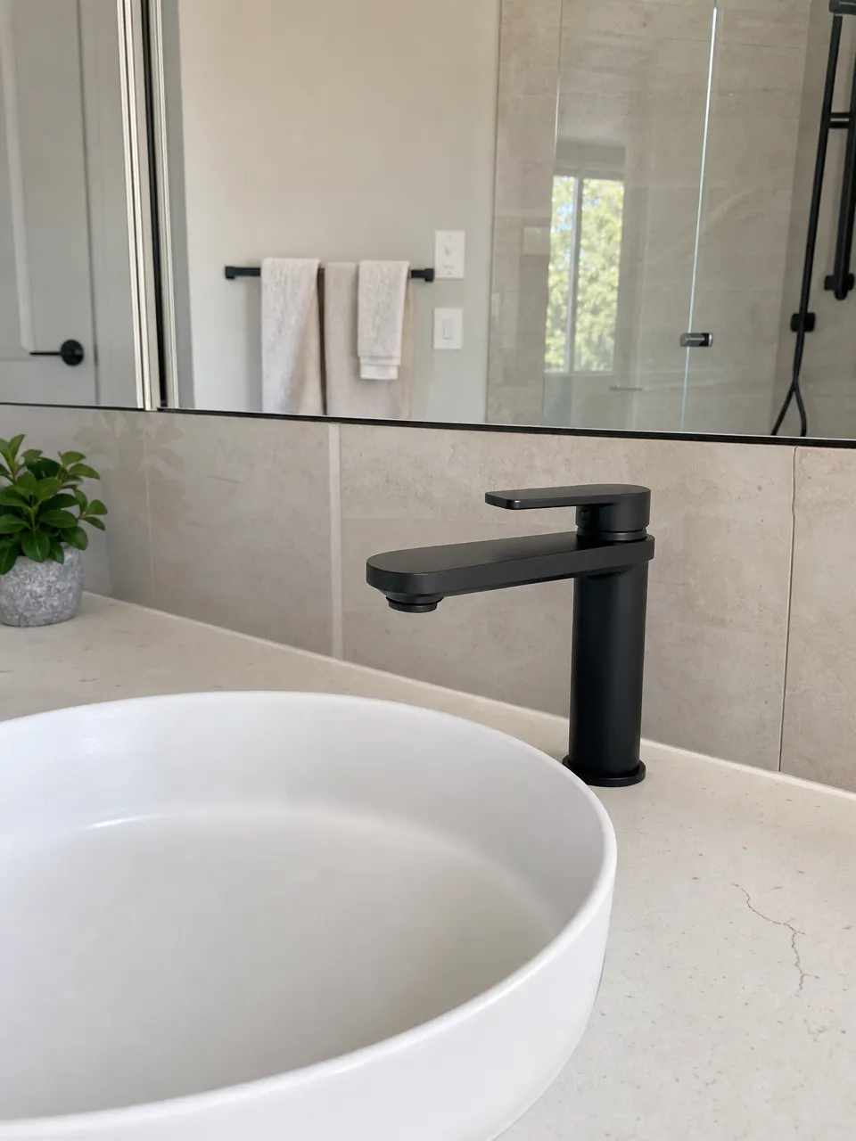 Matte black low profile faucet on vessel sink in premium residential bathroom