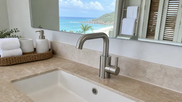 Stainless steel faucet in a coastal resort bathroom resistant to salt air corrosion