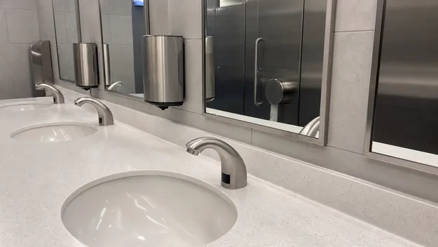 Brushed stainless steel faucet in a high-traffic commercial restroom installation