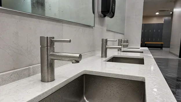 Stainless steel faucet in a gym locker room withstanding high humidity and commercial disinfectant cleaning