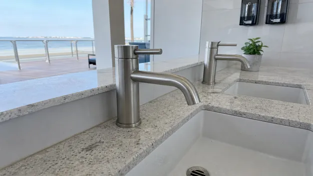 Stainless steel faucet in coastal commercial installation showing corrosion resistance