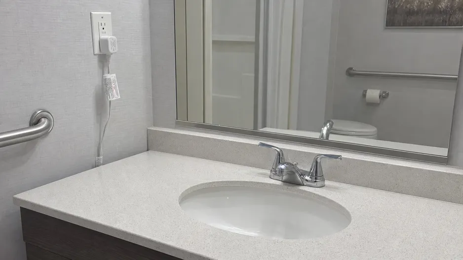 Two handle faucet in an assisted living facility bathroom — healthcare specification application