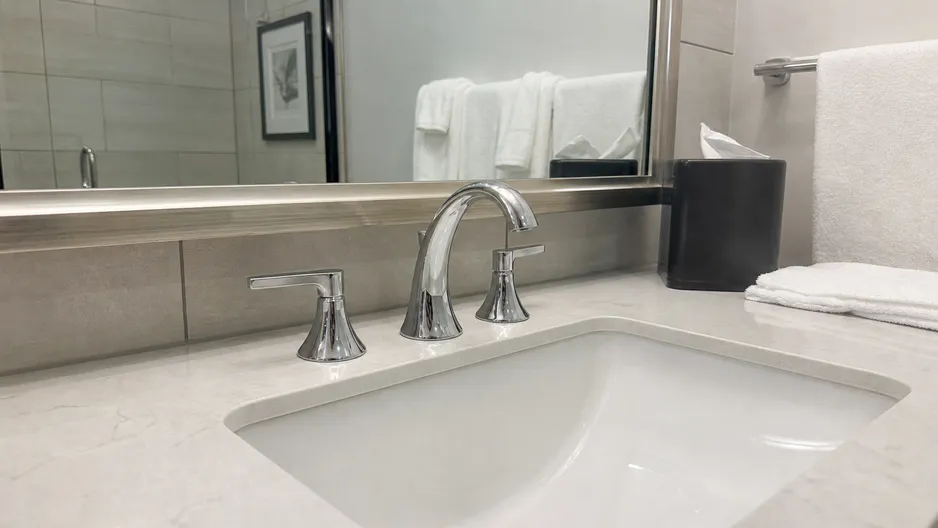 Two handle faucet installed in a hotel bathroom — hospitality fit-out application
