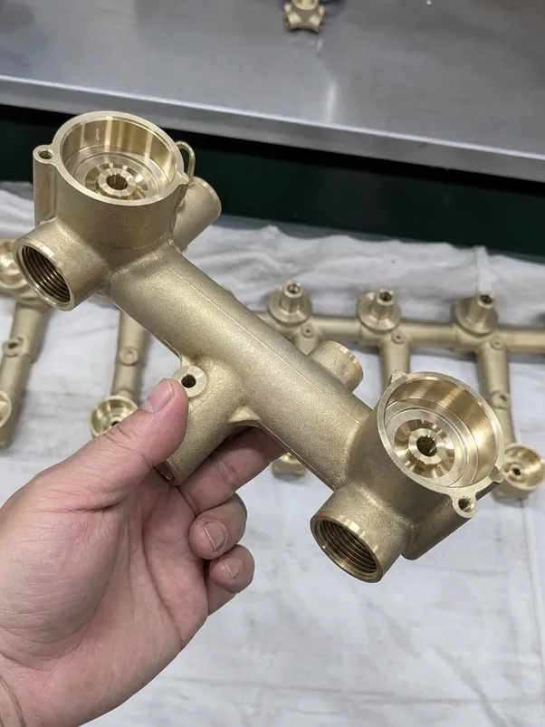 Brass body detail of a two handle bathroom faucet — gravity cast C36000-equivalent free-machining brass