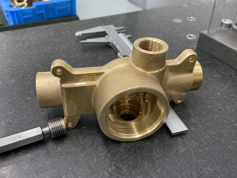 C36000 brass wall mount faucet body after CNC machining showing valve seat thread area
