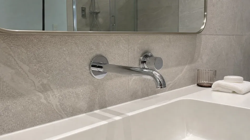 Wall mount faucet specified for hotel bathroom fit-out