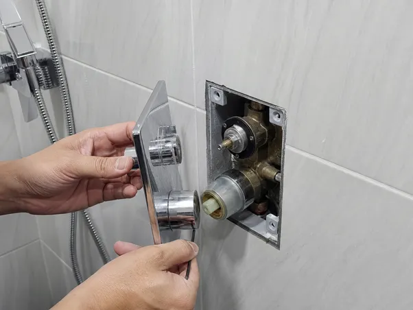 Concealed shower valve trim plate removal for cartridge access and routine maintenance