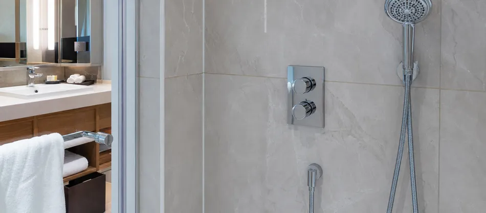 Thermostatic concealed shower mixer installed in hotel bathroom