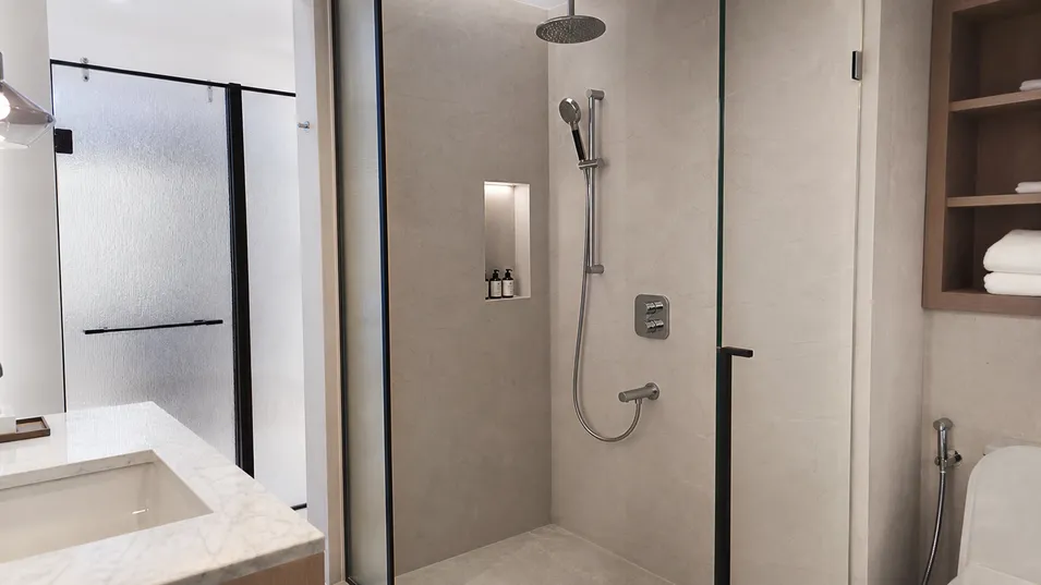 Boutique hotel bathroom with premium concealed shower system specification