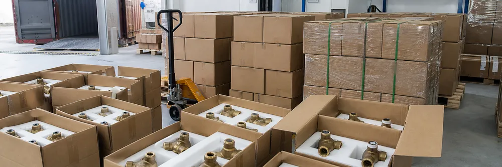 Brass valve bodies in foam-lined cartons prepared for container loading