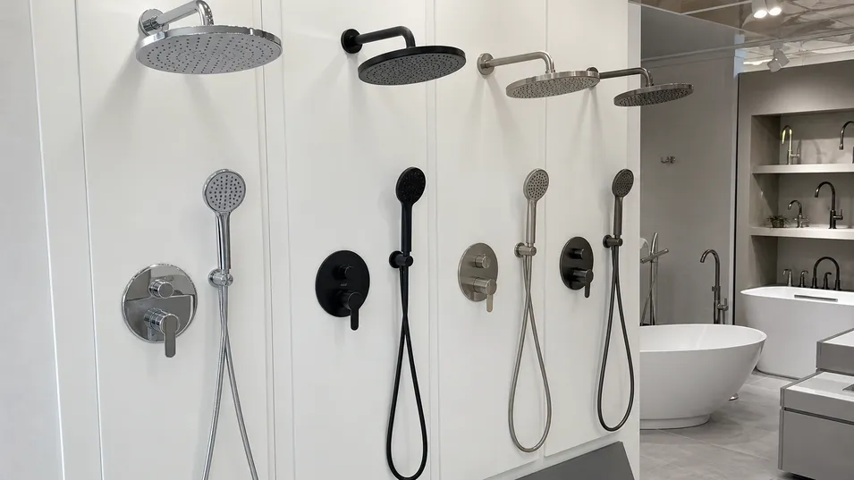 Kitchen and bath showroom display featuring concealed shower mixer in multiple finishes