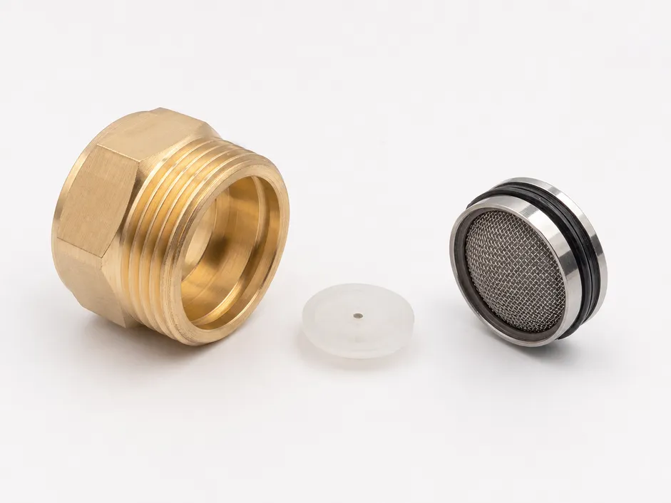 Brass aerator body components showing flow restrictor disc and mesh screen assembly