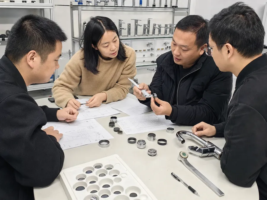 Engineering team reviewing aerator thread dimensions and spec sheet for OEM faucet body matching