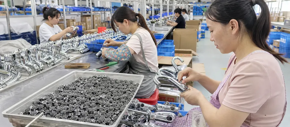 OEM faucet assembly line with aerator components being fitted to spout threads