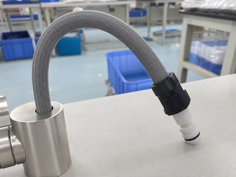 Pull-down kitchen faucet hose showing neck bend radius and quick-connect fitting detail