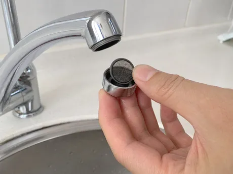 Sink faucet aerator tool-free disassembly showing mesh screen removal for cleaning