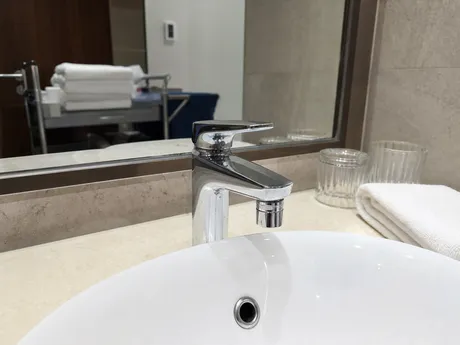 Hotel bathroom sink with cache aerator installed for scheduled maintenance program