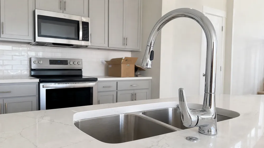 Chrome kitchen faucet installed in residential new construction kitchen renovation project