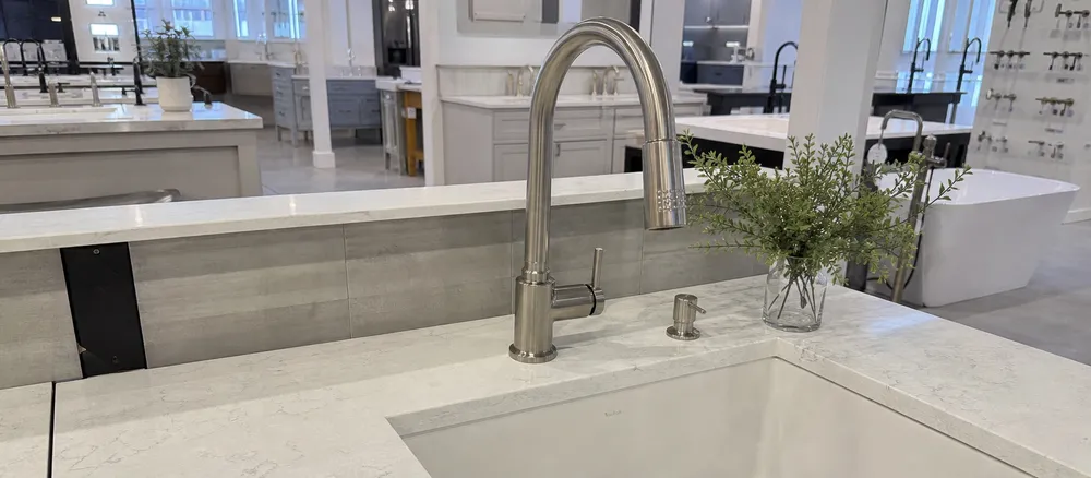 Kitchen and bath showroom display featuring farmhouse faucet