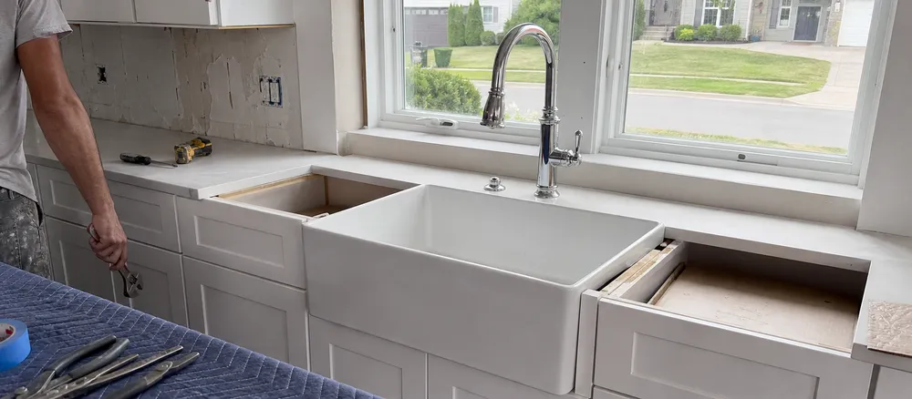 North American residential kitchen renovation with farmhouse faucet installation