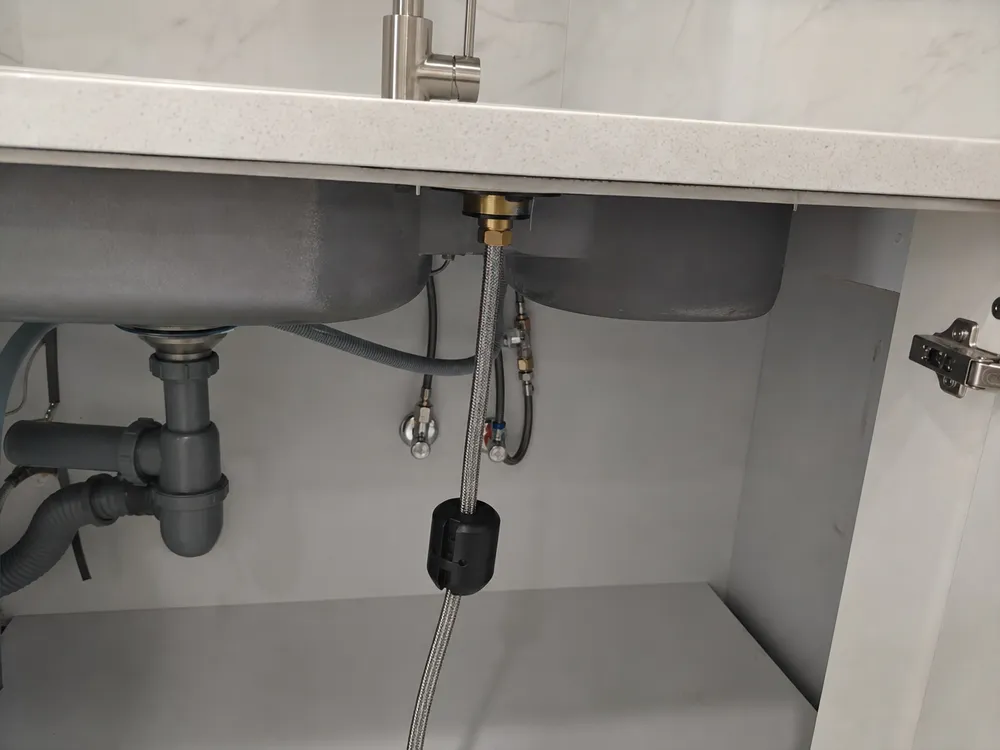 Pull down kitchen faucet retraction mechanism showing weighted counterbalance system below deck
