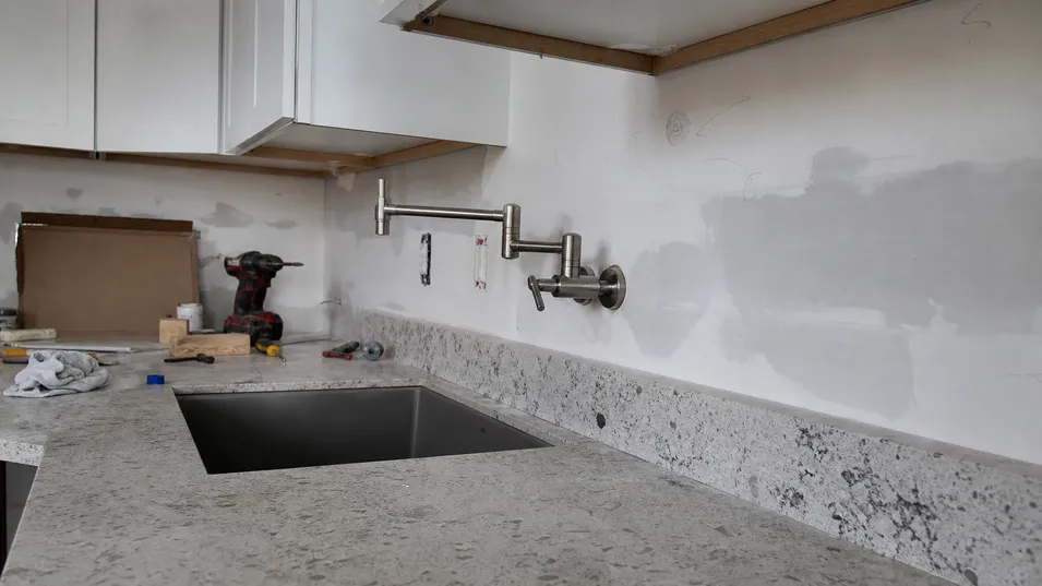 Wall mount faucet installation in kitchen renovation where countertop has no pre-drilled holes