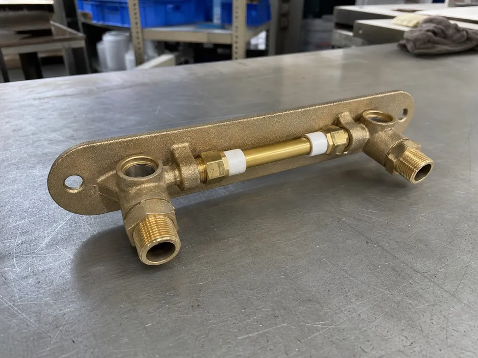 Wall mount faucet rough-in assembly showing adjustable depth supply tube and escutcheon plate