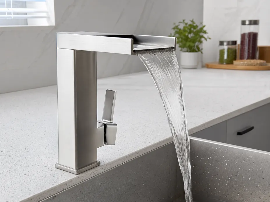 Wide flat spout of waterfall kitchen faucet showing laminar sheet-flow water delivery