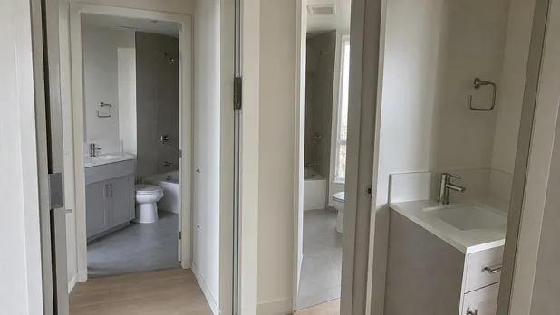 Brushed nickel faucets installed across multiple units in a property development