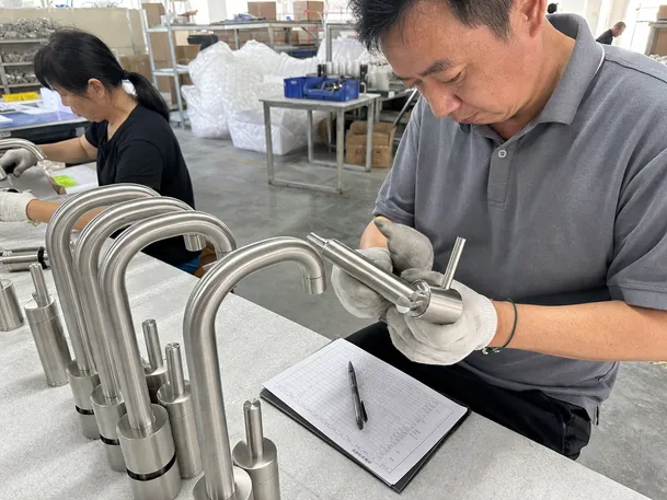 Quality control inspection of brushed nickel faucets during production
