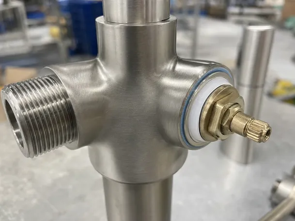 Brushed nickel faucet technical detail showing valve and connection points