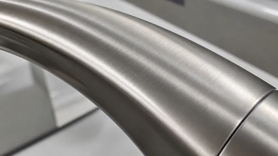 Close-up of brushed nickel faucet finish showing directional matte texture and plating quality