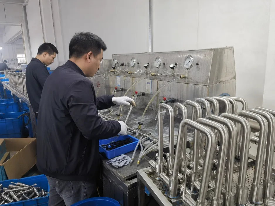 Stainless mixer tap manufacturing — quality control inspection and pressure testing on the production line
