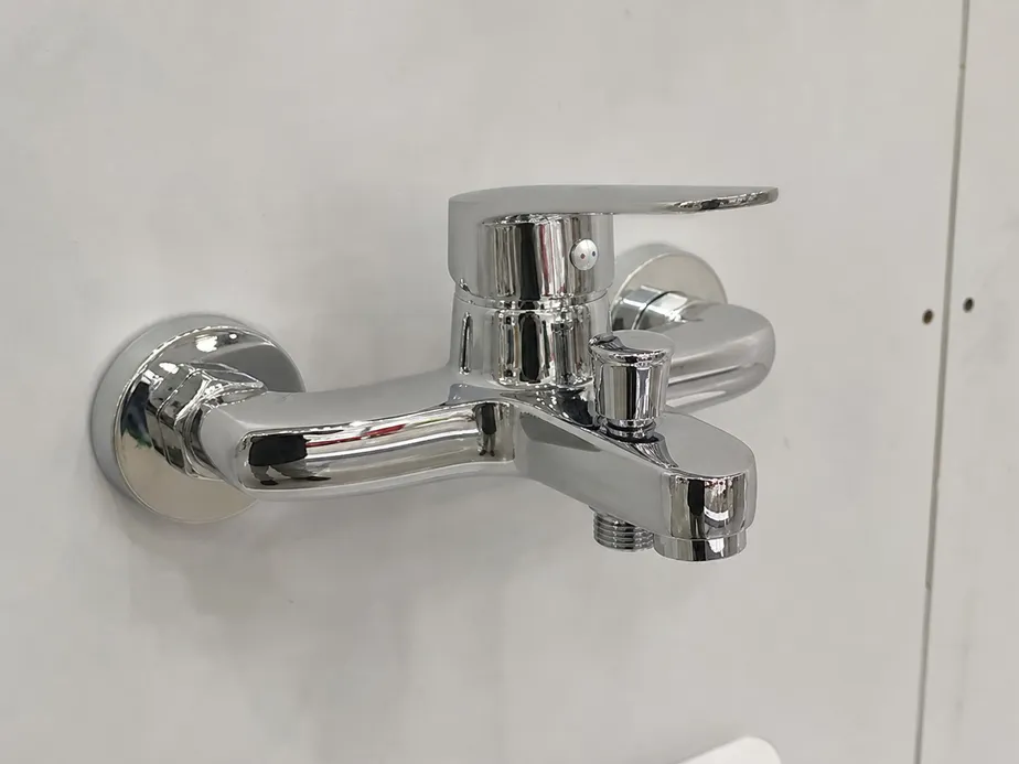Brass-body bathroom shower faucet with chrome finish, wall-mounted surface installation