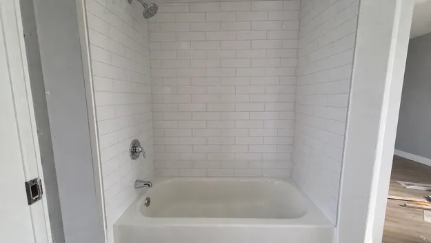 Standard alcove tub/shower enclosure in North American residential renovation context
