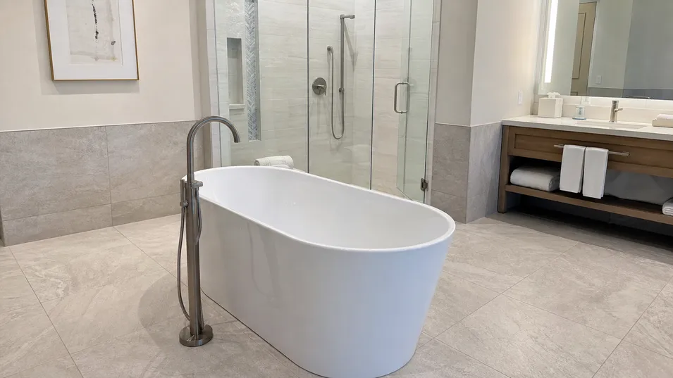 Hotel suite bathroom with freestanding bathtub faucet for hospitality procurement
