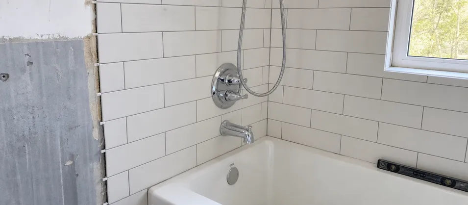 Residential renovation bathroom with two-handle shower faucet installation