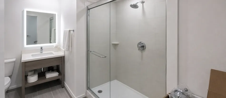 Hotel guest bathroom renovation with single handle shower valve specification across all rooms