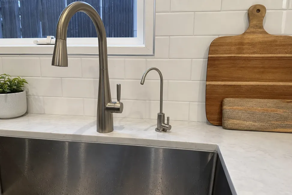 Brushed nickel filter faucet installed in a kitchen remodel — residential distribution channel