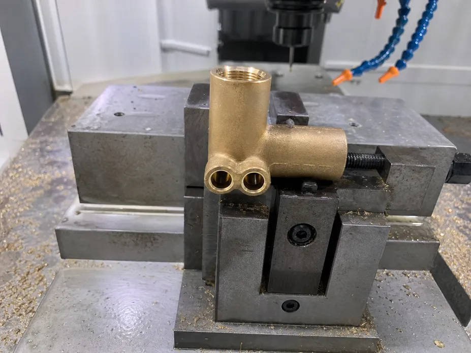 Close-up of the brass body machining on a non-air gap RO faucet showing the two-port bore configuration