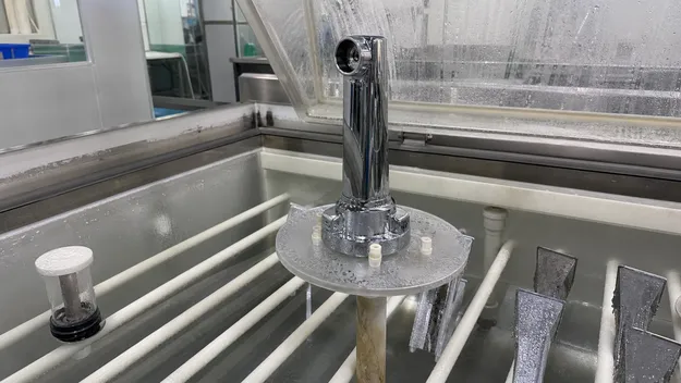 RO faucet base plating undergoing salt spray corrosion test showing full copper-nickel-chrome electroplating stack
